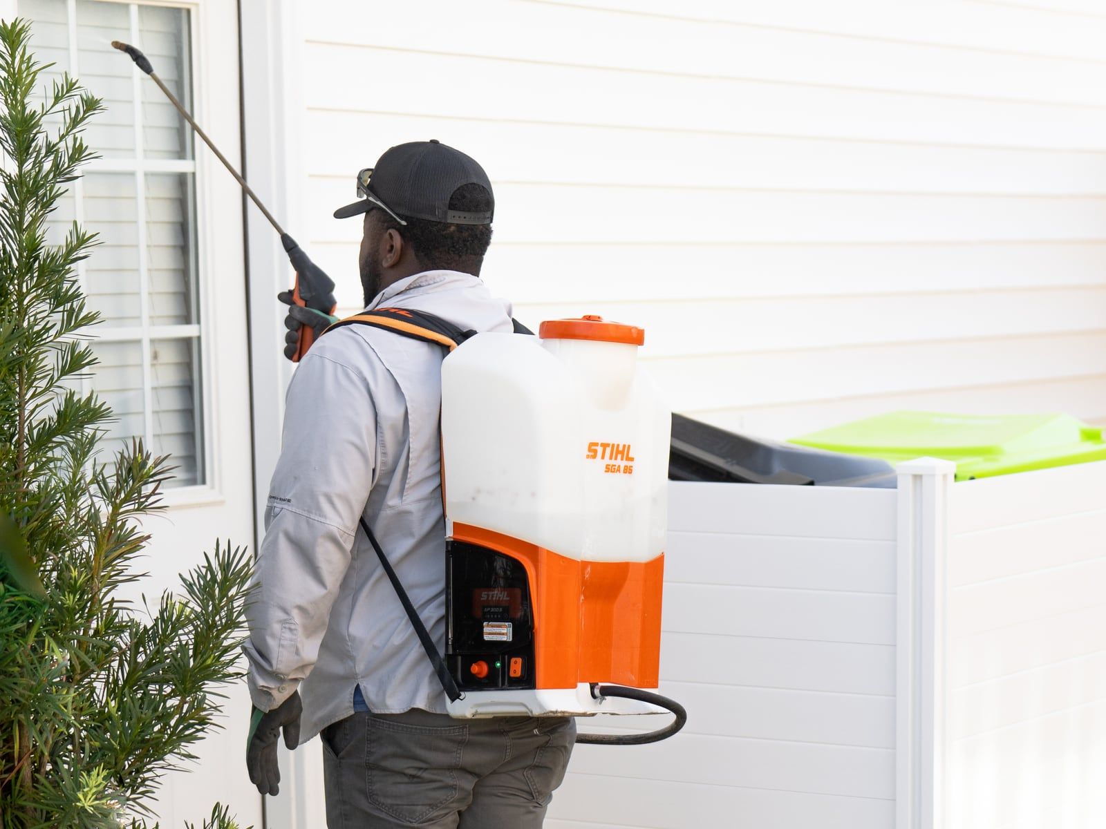 Diamond Pest Pro technician spraying a home's exterior perimeter